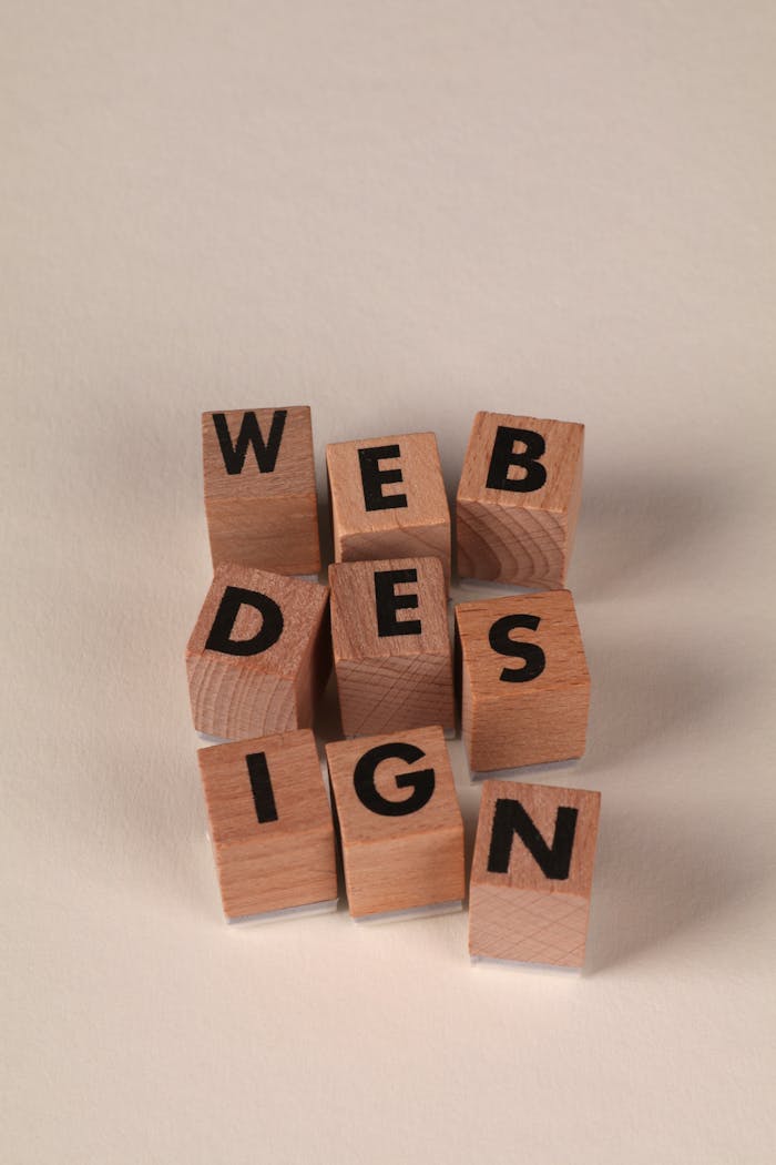 services-04 Wooden blocks arranged to spell Web Design. Perfect for creative, digital content themes.